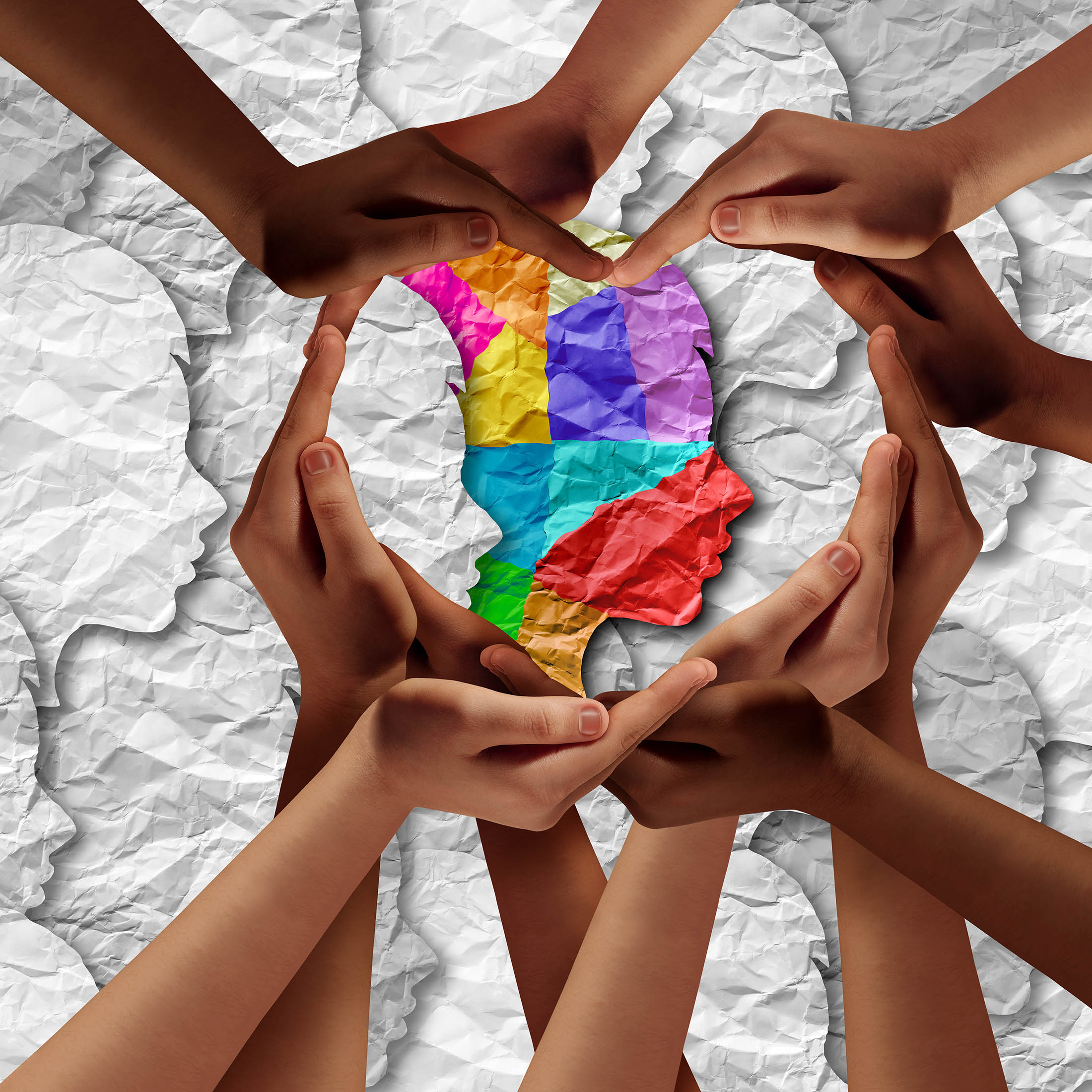 Artistic montage of hands surrounding a cutout of a person's head